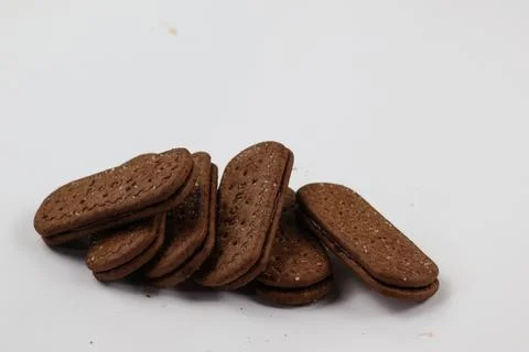 A stack of delicious brown wheat round biscuits with a few crumbs Foto stock