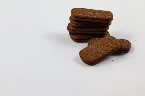 A stack of delicious brown wheat round biscuits with a few crumbs Stock-Fotos