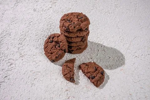 A Stack Of Delicious Chocolate Cookies With One Cookie Broken In Half, Plac.. Stock Photos