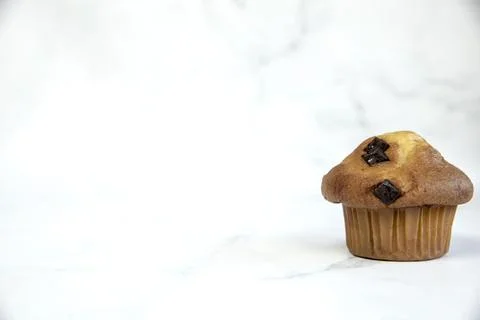 A stack of delicious chocolatechip banana muffins and blueberries on a white Stock Photos