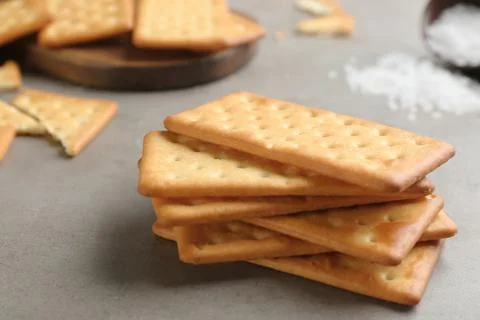 Stack of delicious crackers on grey table, closeup Stock Photos