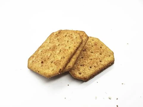 Stack of delicious crackers seasoned with spices on a white background Stock Photos