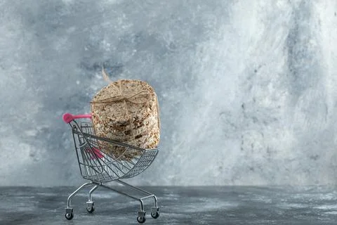 Stack of delicious crispbread in small shopping cart Stock Photos