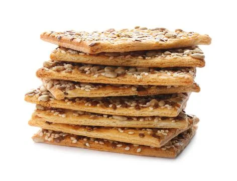 Stack of delicious crispy crackers with different seeds isolated on white Stockfoto's