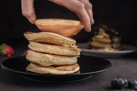 Stack of delicious pancakes on a black plate Stock Photos
