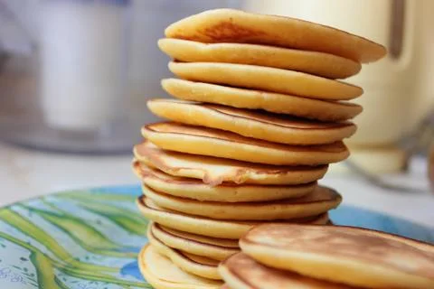 A stack of delicious pancakes is on a blue plate Stock Photos