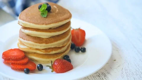 Stack of delicious pancakes with honey and berries Stock Footage 73079402