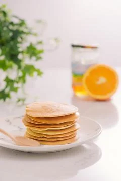 Stack of delicious pancakes on plate isolated on white Stock Photos