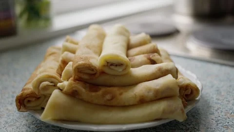 A Stack of Delicious Rolled Crepes Arranged Beautifully on a Plate Ready to Video stock 304679827