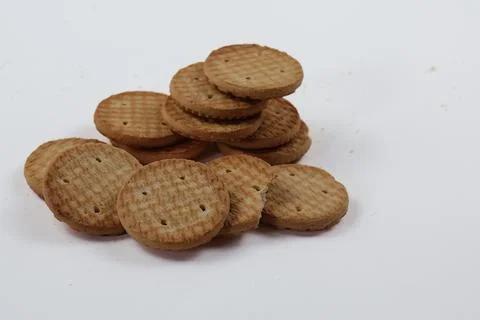 A stack of delicious wheat round biscuits with a few crumbs Foto stock