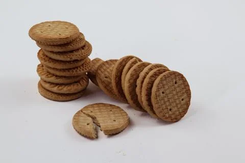 A stack of delicious wheat round biscuits with a few crumbs Stockfoto's