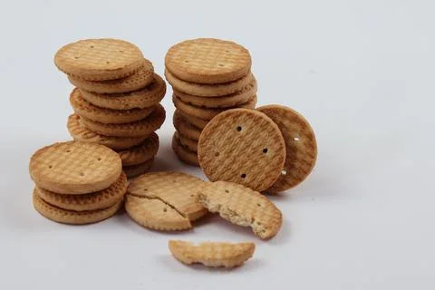 A stack of delicious wheat round biscuits with a few crumbs Stock Photos