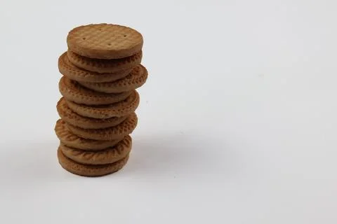 A stack of delicious wheat round biscuits with a few crumbs Stock Photos