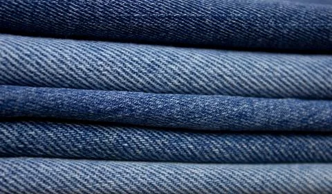 A stack of denim. Color denim close-up texture. Stock Photos