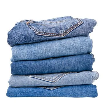 Stack of denim pants on isolated background Stock Photos