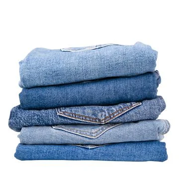 Stack of denim pants on isolated background Stock Photos
