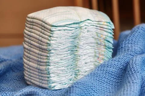 Stack of diapers or nappies on knitted blanket Stock Photos