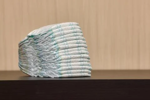 Stack of diapers or nappies on table, copyspace Stock Photos