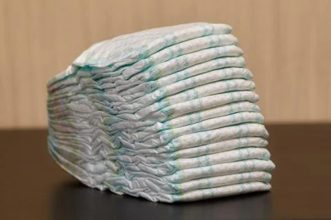 Stack of diapers or nappies on table, copyspace Stock Photos