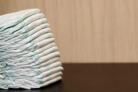 Stack of diapers or nappies on table, copyspace Stock Photos