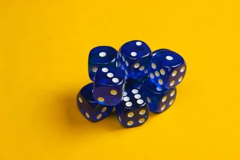 Stack of dice on a yellow background Stock Photos