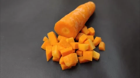 Stack of Diced Carrots on A Black Background Stock Footage 279615326