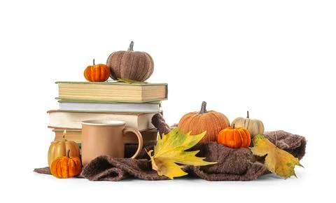 Stack of different books with burning candle, decorative pumpkins, cup of coc Stock Photos