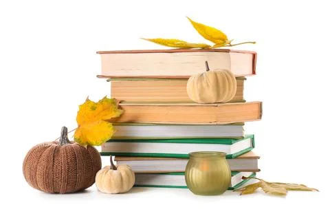 Stack of different books with burning candle, decorative pumpkins and autumn  Stock Photos