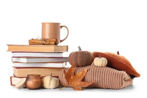 Stack of different books with cup of cocoa, beret hat, sweater and autumn dec Stock Photos