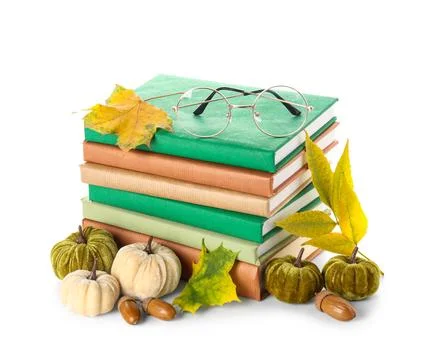 Stack of different books with decorative pumpkins, eyeglasses, acorns and aut Stock Photos