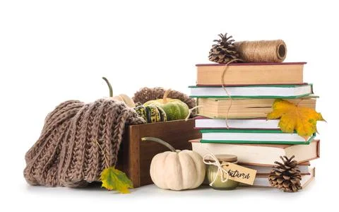 Stack of different books with knitted scarf, pumpkins, candle, cones and autu Stock Photos