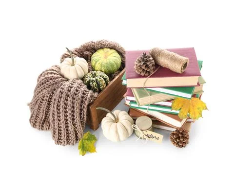 Stack of different books with knitted scarf, pumpkins, candle, cones and autu Stock Photos