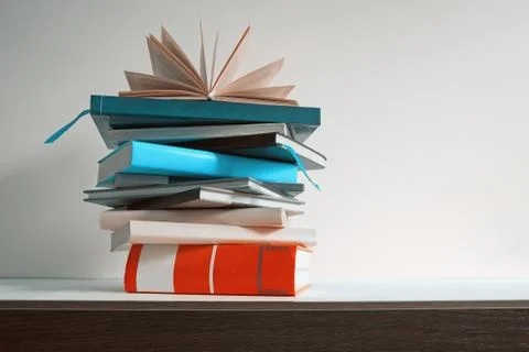 Stack of different books on the table, free space for text Foto stock