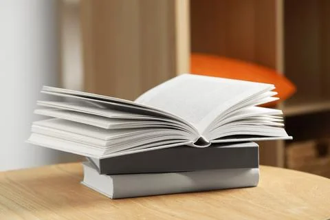 Stack of different books on wooden table indoors 스톡 사진