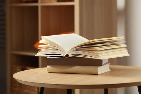 Stack of different books on wooden table indoors, space for text Stockfoto's