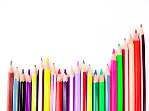 A stack of different colored pencil crayons arranged on a white background Stock Photos
