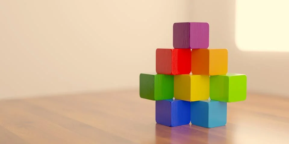 Stack of different colored wood blocks on wooden floor in white room backgr.. Illustrazione stock