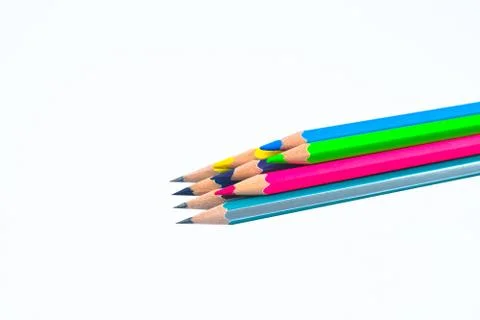 Stack of different colored wood pencil crayon placed on top of a white backgr Stock Photos