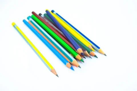 Stack of different colored wood pencil crayons placed on a white background Stock Photos