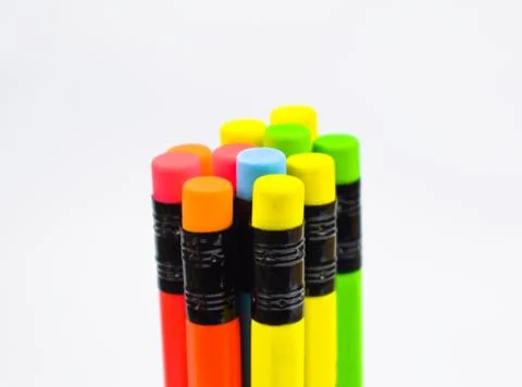 Stack of different colored wood pencil crayons placed on a white background Stock Photos