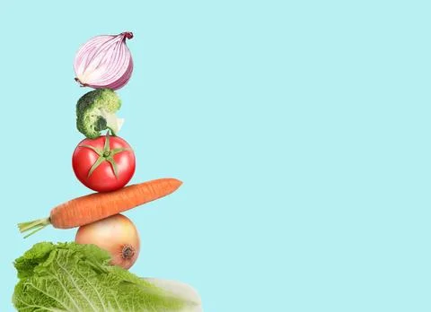 Stack of different fresh vegetables on light blue background, space for text Stockfoto's