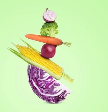 Stack of different fresh vegetables on light green background 스톡 사진