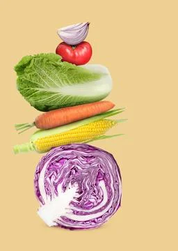 Stack of different fresh vegetables on light gold background 스톡 사진