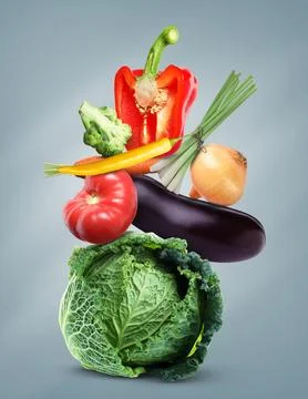 Stack of different fresh vegetables on light slate grey background Stockfoto's
