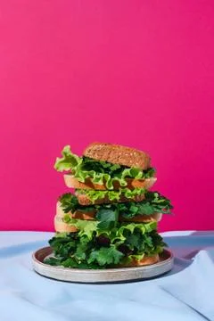 Stack of different kind of bread with various greens on a drapery, concept of Stock Photos
