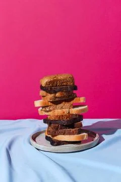 Stack of different kinds of bread: rye; whole-wheat and white on a drapery, s Stock Photos