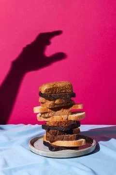Stack of different kinds of bread: rye; whole-wheat and white on a drapery wi Stock Photos