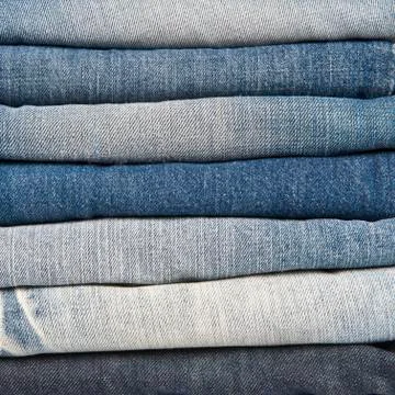 Stack of different old worn blue jeans Stock Photos