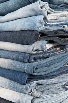 Stack of different old worn blue jeans Stock Photos