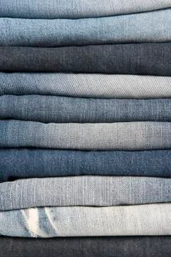 Stack of different old worn blue jeans Stock Photos